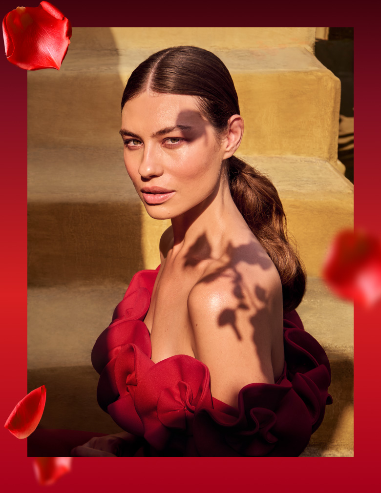 Woman in a red dress representing The Ritual of Ayurveda collection.